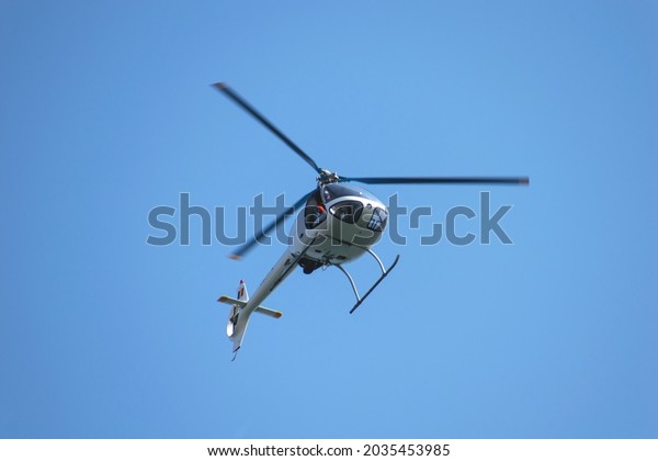 Small\
helicopter in flight. Helicopter for two\
people.