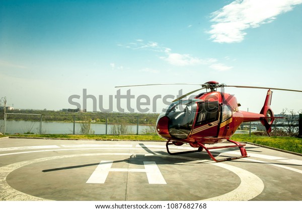 Small\
helicopter parked at the helipad. Luxury\
lifestyle