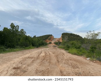The small hill that is split to be used as a road, at a glance, destroys nature