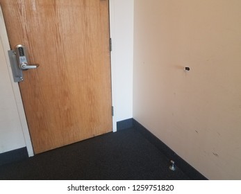 Small Hole Damage In A Drywall Wall With Door