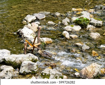 Small Home Made Kid Water Mill On Stream Of A River.