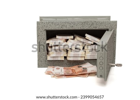 Small, home safe full of bundles of Russian rubles in 5000 banknotes, isolated on a white background