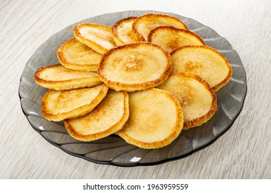 Small homemade pancakes in gray transparent plate on wooden table - Shutterstock ID 1963959559