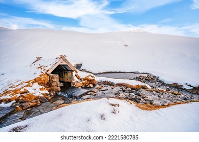 Small hot spring in Hrunalaug, winter Iceland. Bathes in a hot spring in the open air with a gorgeous view of the snowy mountains. - Powered by Shutterstock