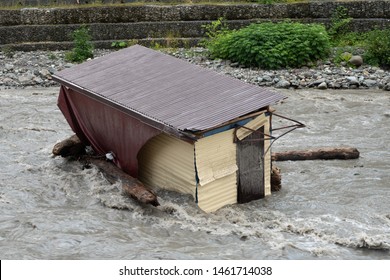 A Small House Destroyed The Mudflow In The Mountains. A Small House Was Washed Away By A Flooded Mountain River. The Devastating Effects Of A Flood Or Mudshed.