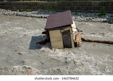 A Small House Destroyed The Mudflow In The Mountains. A Small House Was Washed Away By A Flooded Mountain River. The Devastating Effects Of A Flood Or Mudshed.