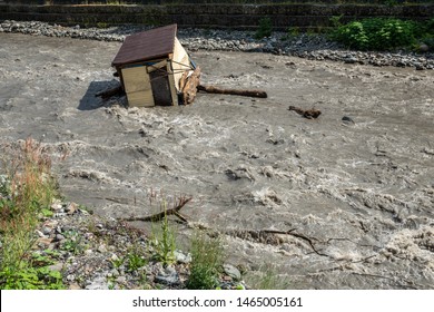 A Small House Destroyed The Mudflow In The Mountains. A Small House Was Washed Away By A Flooded Mountain River. The Devastating Effects Of A Flood Or Mudshed.