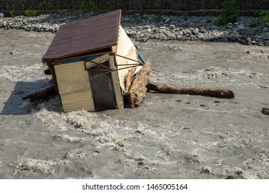 A Small House Destroyed The Mudflow In The Mountains. A Small House Was Washed Away By A Flooded Mountain River. The Devastating Effects Of A Flood Or Mudshed.