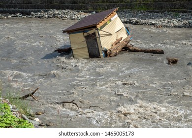 A Small House Destroyed The Mudflow In The Mountains. A Small House Was Washed Away By A Flooded Mountain River. The Devastating Effects Of A Flood Or Mudshed.