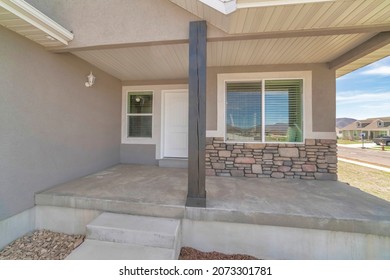 Small House Exterior With Stone Veneer Siding And White Door