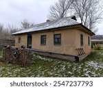 A small house with a metal roof in the snow.