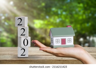 Small house model with number 2022, concept to save money buying house, real estate and property concept. - Shutterstock ID 2116211423
