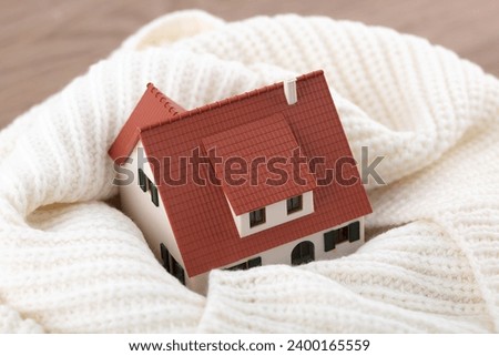 The small house model is wrapped around the neck for warmth