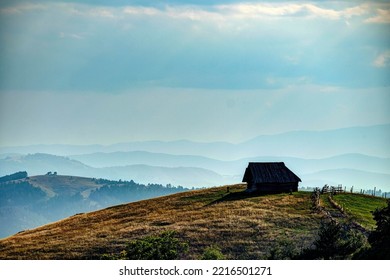 A small house standing on a hill with the background of mountain ranges far away, Zlatibor, Serbia