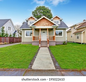 Small House With Wooden Column Porch. View From Walkway