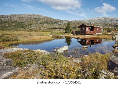 small hut at norwegian lake in hardanger vidda  - Powered by Shutterstock