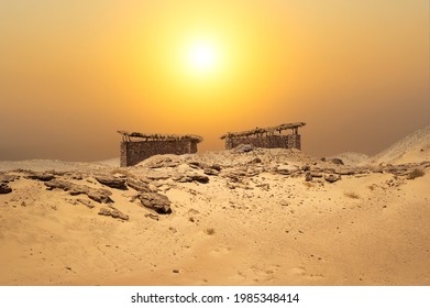 Small huts in the middle of the desert with an amazing landscape background. Desert stone hut under the scorching sun. Desert sunset - Powered by Shutterstock