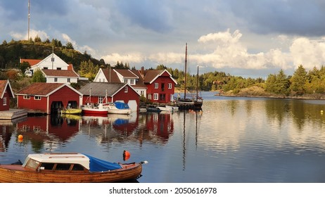 Small idyllic southern town Farestad on Skjernøy with boats and houses outside of Mandal, Norway - August 20, 2021