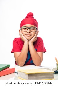 Small Indian/sikh Boy Studying At Study Table With Books