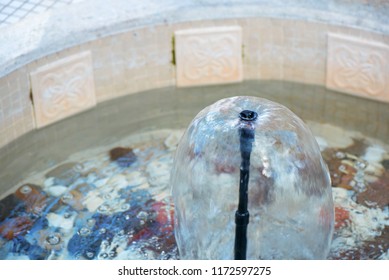 Small Indoor Fountain In A Pool With Decorative Stones, Pebbles And Rocks. Clean Water  
