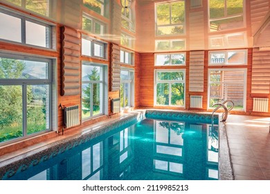 Small indoor pool in a wooden house. Picturesque summer day in Carpathian village. Splendid morning scene of mountain resort.