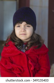 Small Iraqi Girl Wearing Red Coat In Winter Season