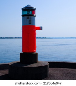 Small Island Lighthouse By End Of Peer