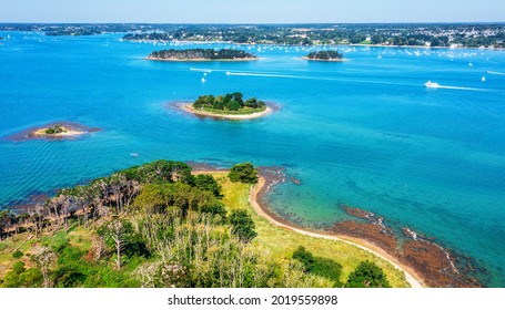 Small islands scattered in the blue water of the Gulf of Morbihan on atlantic coas of Brittany, France