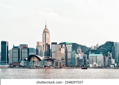 Small Junk And Victoria Harbor In Hong Kong. View From Kowloon On HK Island.