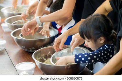 Small Kid And Family Is Learning How To Make Ice Cream In A Cooking Class. Parent Are Helping Children In Baking Sweet Bakery In A Cooking Group Club Activity.