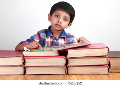 A Small Kid Looks While Reading Big Old Books