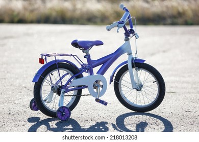 Small Kids Bike With Training Wheels Outdoors.