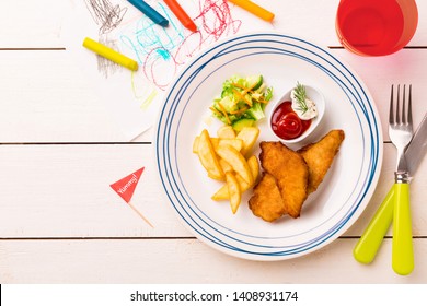 Small Kid's Meal - Fried Chicken Strips, French Fries, Salad And Ketchup. Colorful Dinner On White Wooden Table. Plate Captured From Above (top View, Flat Lay). Layout With Free Copy (text) Space.