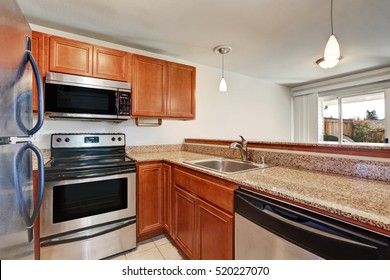 Small Kitchen Features Shaker Cabinets Paired With Granite Countertop. Northwest, USA
