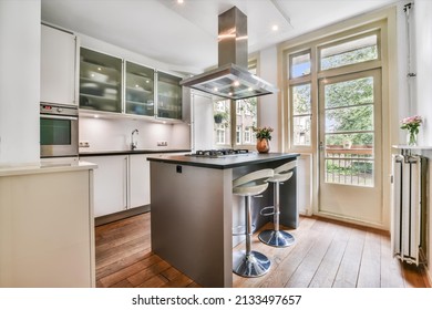 Small Kitchen With Island And Hood Over The Island