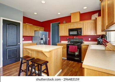 Small Kitchen With Island, Also Red And Gray Walls.