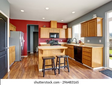 Small Kitchen With Island, Also Red And Gray Walls.