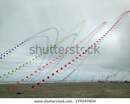 Similar – a colorful garland blows in the wind on the north sea