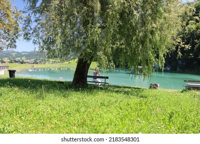 Small Lake Of Hydroelectric Power Plant. Green Energy Is Produced Just There With A Hydroelectric Turbine And Water From This Idyllic Lake In Front. Electricity Without Co2 Emmissions.