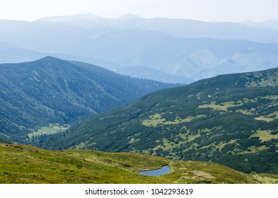 A small lake in a mountain range.