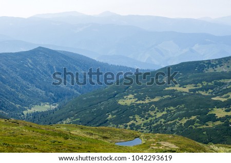 A small lake in a mountain range.