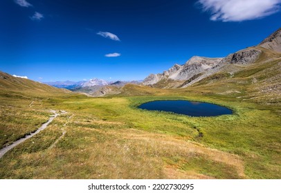 A small lake in a mountain valley. Mountain lake view. Lake in mountains. Mountain lake landscape - Shutterstock ID 2202730295