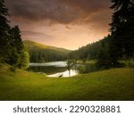 Small lake at sunset. Akgol lake in Ayancik district. Small lake and pine forests in the mountain. Sinop, Turkey