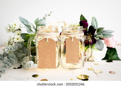 Small And Large Blank Brown Cardstock Tags Hanging On Mason Jar Mugs With Wedding Decor, Party Favor Label Mockup