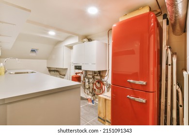 A Small Laundry Room With Appropriate Appliances Indoors In A Modern Residential Apartment