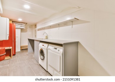 A Small Laundry Room With Appropriate Appliances Indoors In A Modern Residential Apartment