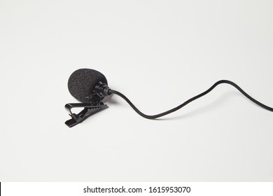 Small Lavalier Microphone Isolated On White Background. Professional Sound Recording Equipment. Lapel Mic. 