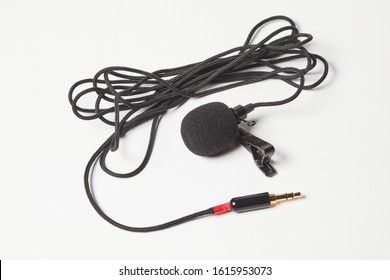 Small Lavalier Microphone Isolated On White Background. Professional Sound Recording Equipment. Lapel Mic. 