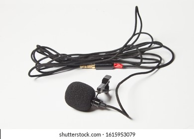 Small Lavalier Microphone Isolated On White Background. Professional Sound Recording Equipment. Lapel Mic. 