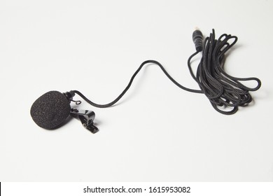 Small Lavalier Microphone Isolated On White Background. Professional Sound Recording Equipment. Lapel Mic. 